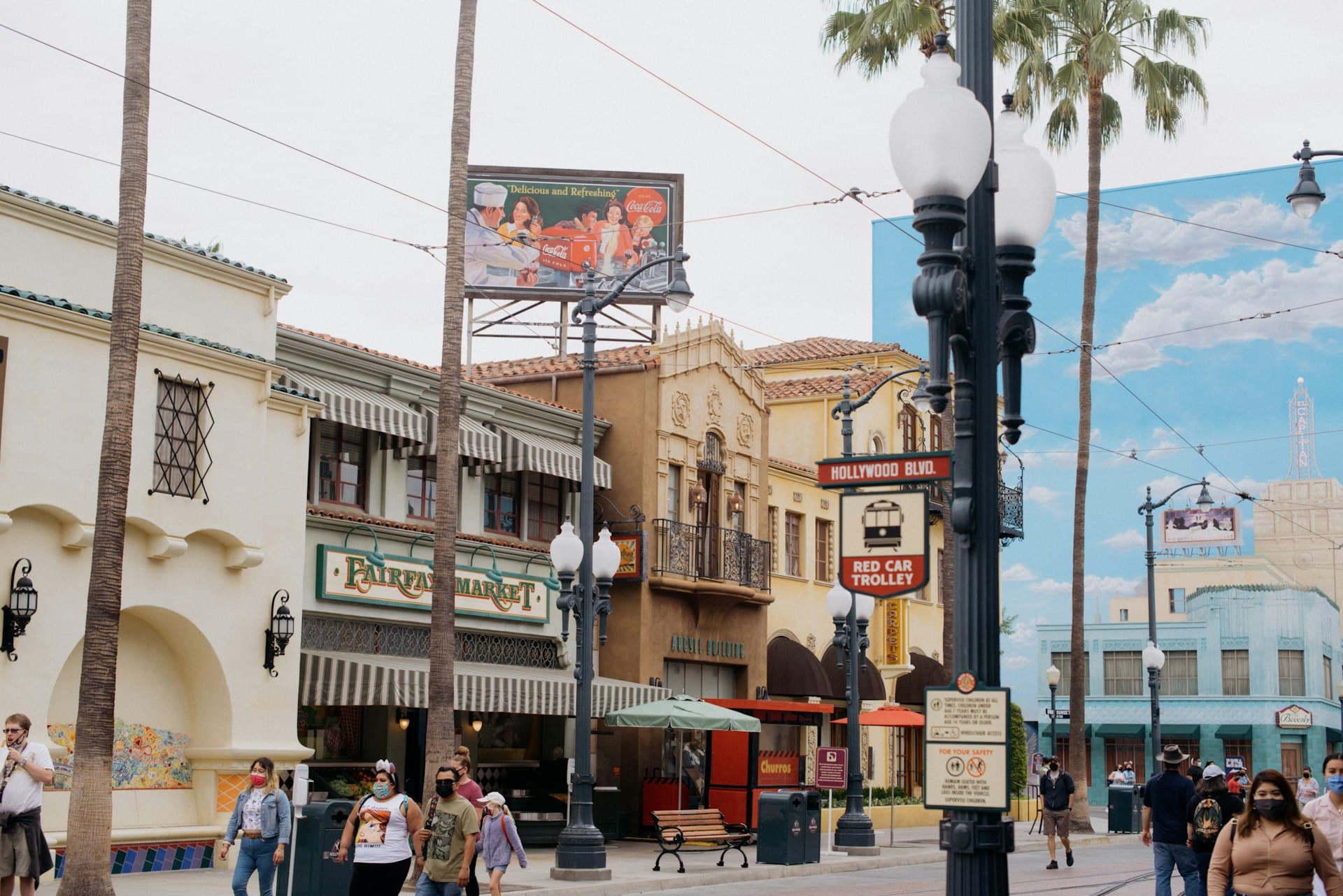 Street scene near Disneyland Resort area in Anaheim with palm trees and pedestrians