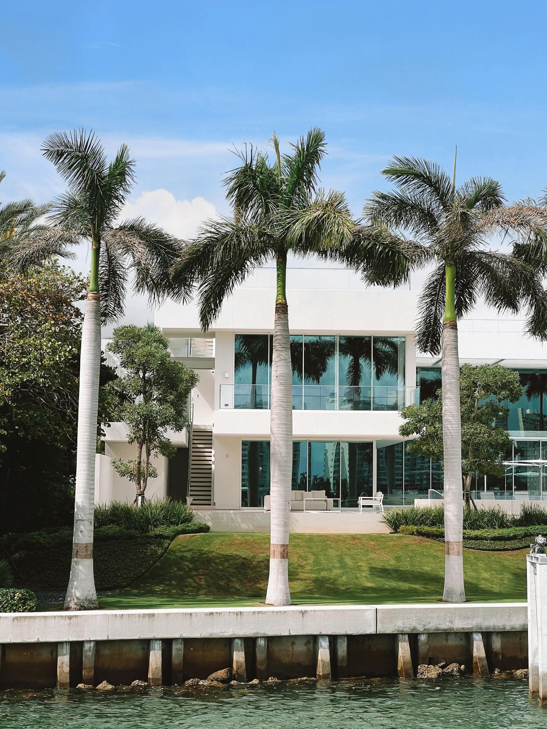 Modern waterfront villa with palm trees in Southwest Florida