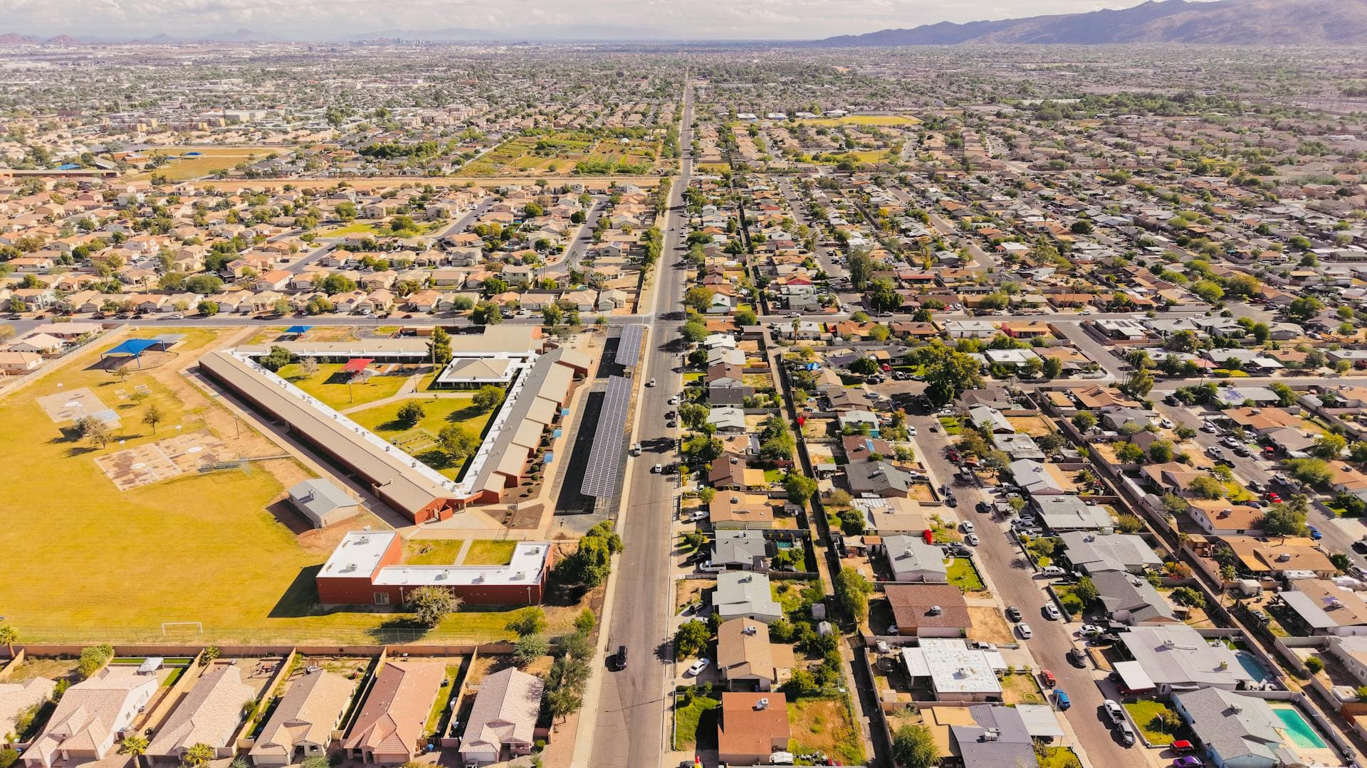 Aerial view of Arizona residential neighborhood with mountains in distance