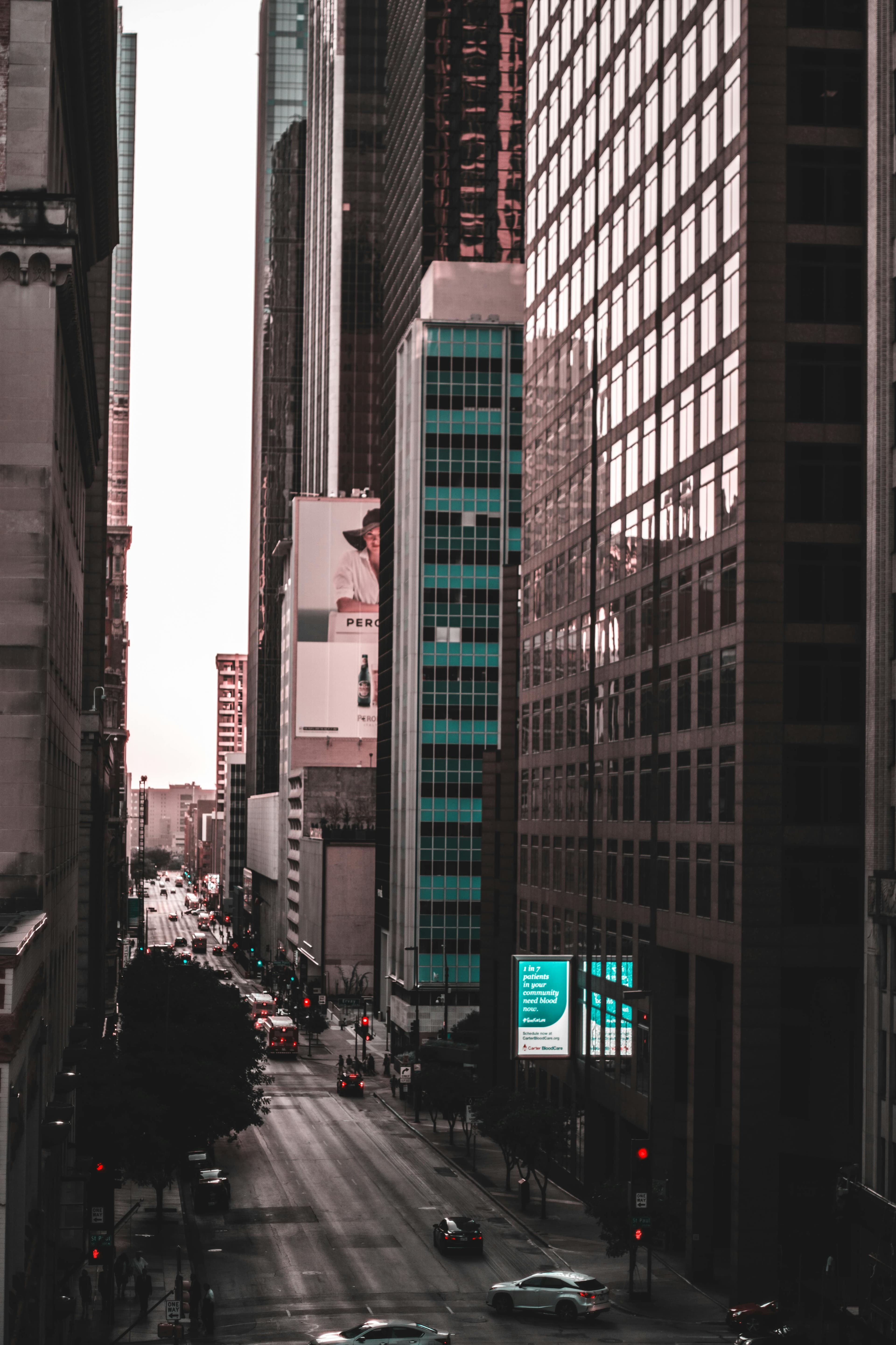 Downtown Dallas street canyon with skyscrapers and urban commercial district at sunset