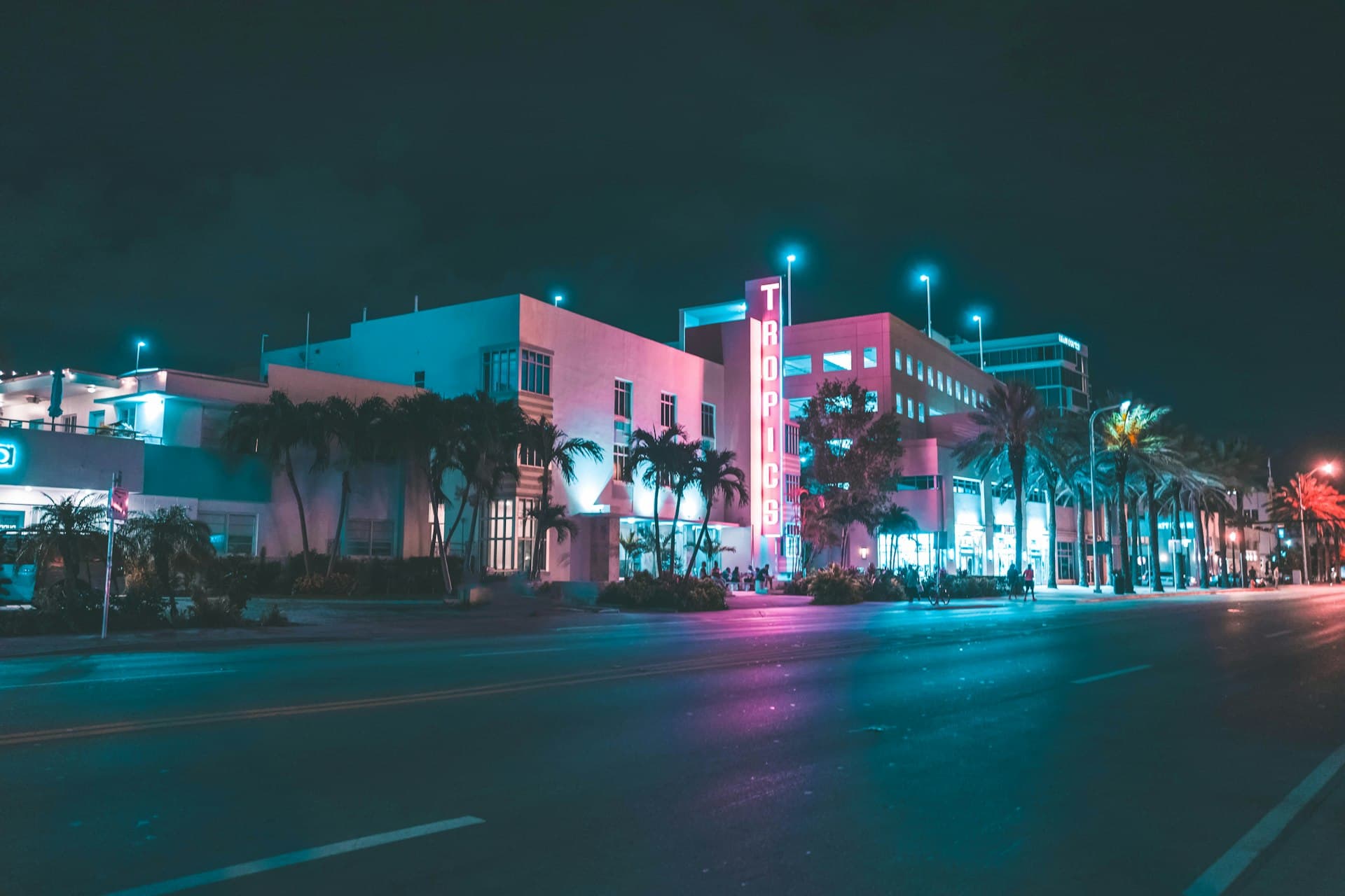 Miami Art Deco district at night with neon lights and palm trees