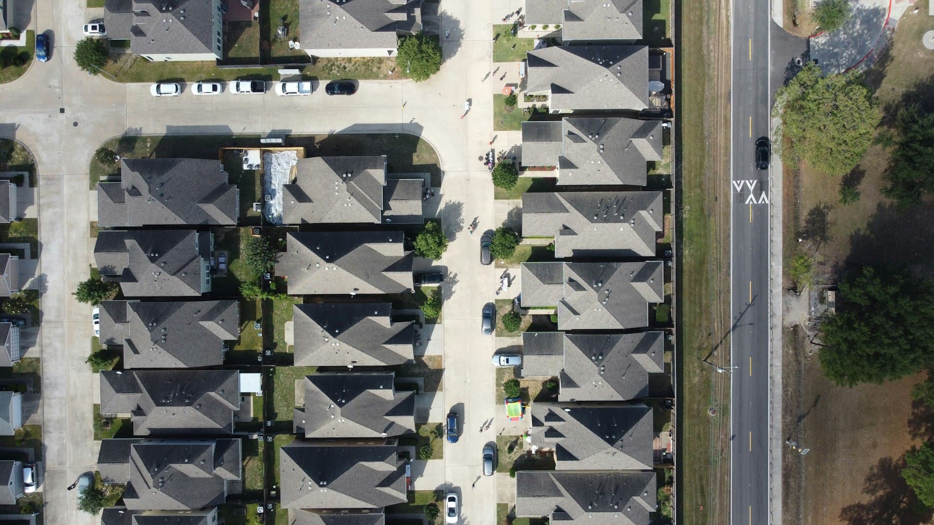 Aerial view of suburban neighborhood homes with rooftops showing HVAC-relevant residential area