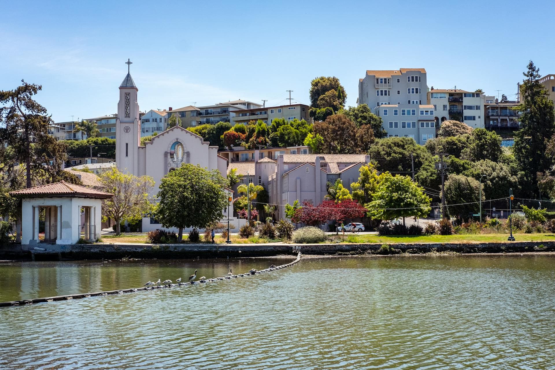 Oakland waterfront neighborhood with Our Lady of Lourdes Church and residential buildings near Lake Merritt