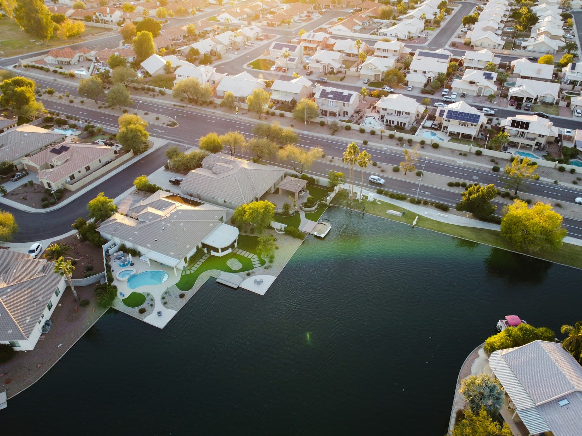 Aerial view of lakefront homes with pools in Peoria Arizona master-planned community