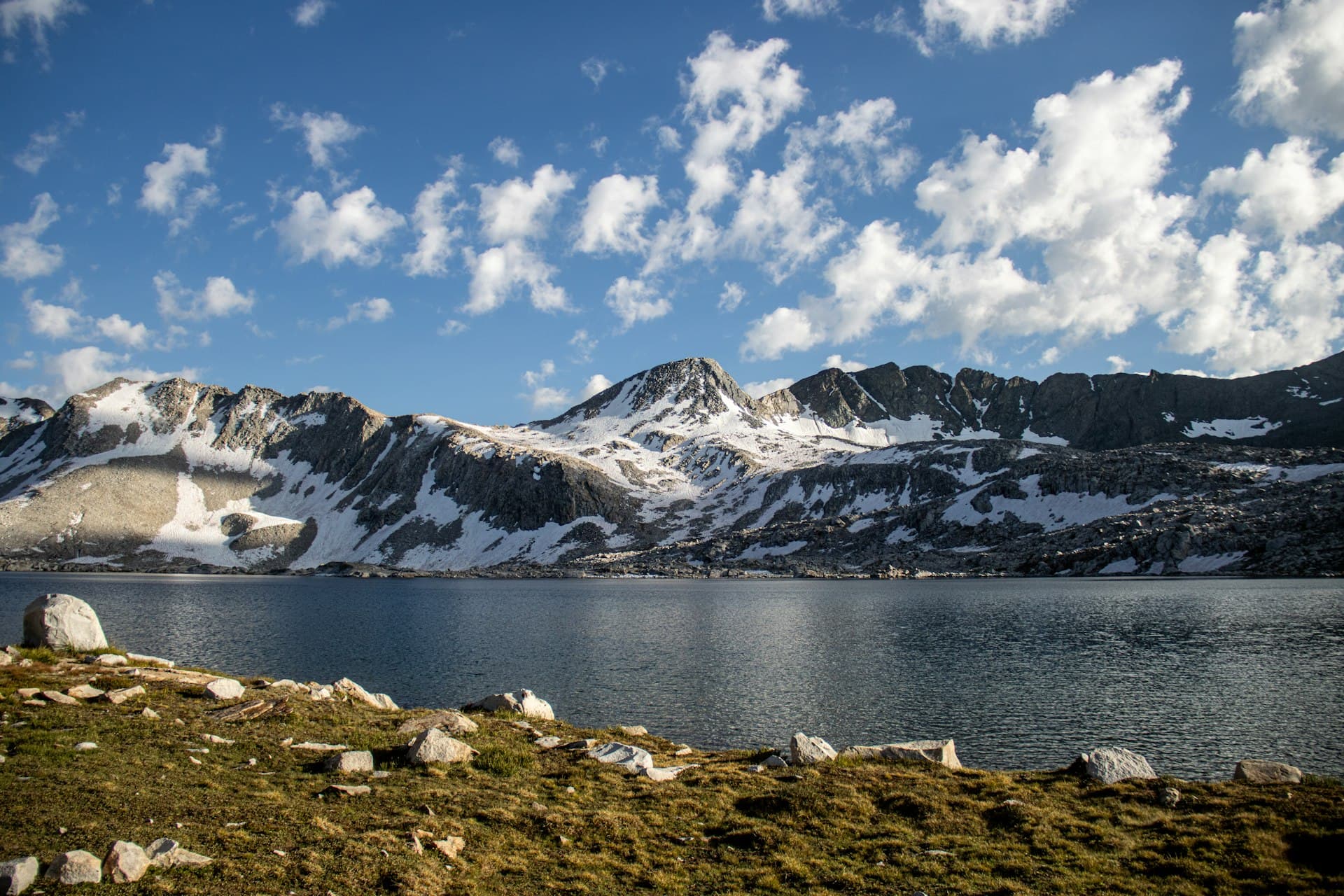 Sierra Nevada alpine lake with snow-capped mountain peaks
