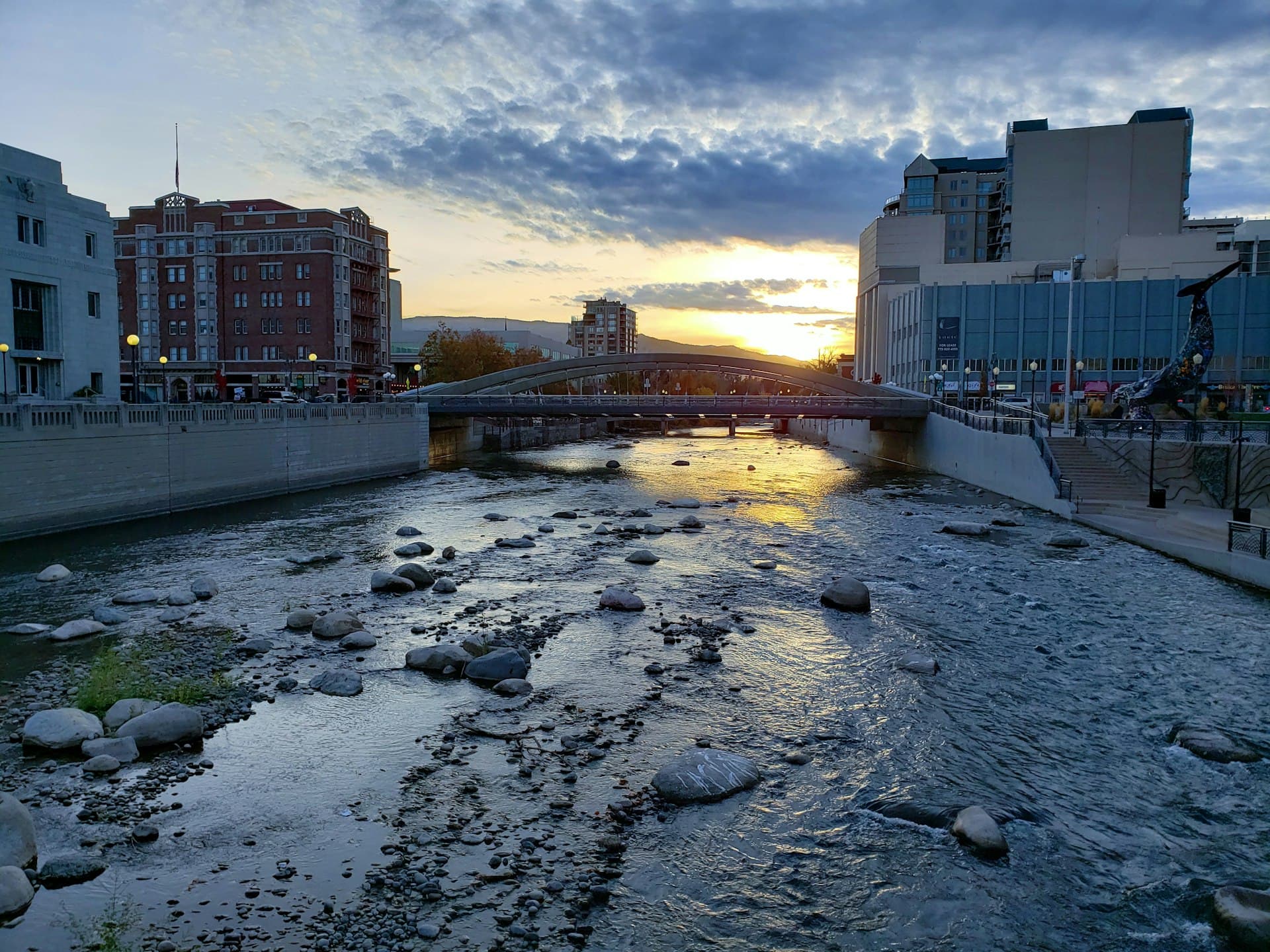 Truckee River flowing through downtown Reno Riverwalk District at sunset