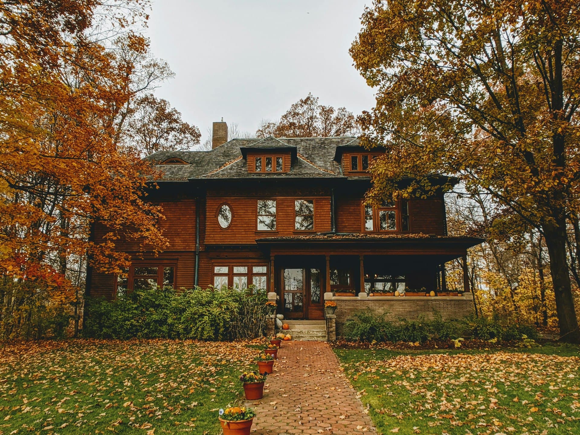 Historic midwest home with craftsman architecture surrounded by autumn trees