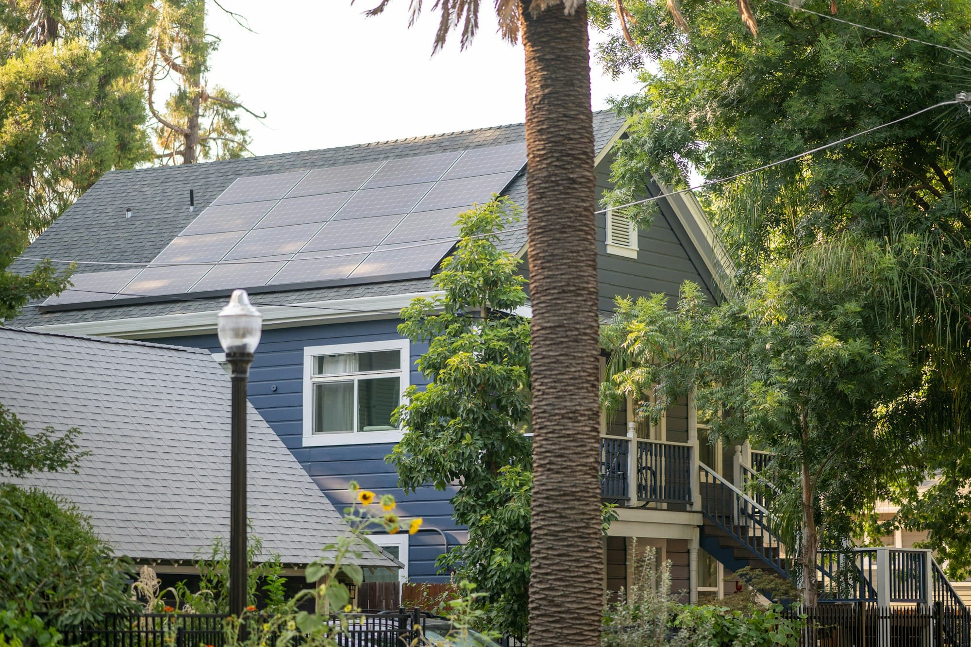 Sacramento California home with solar panels and palm trees