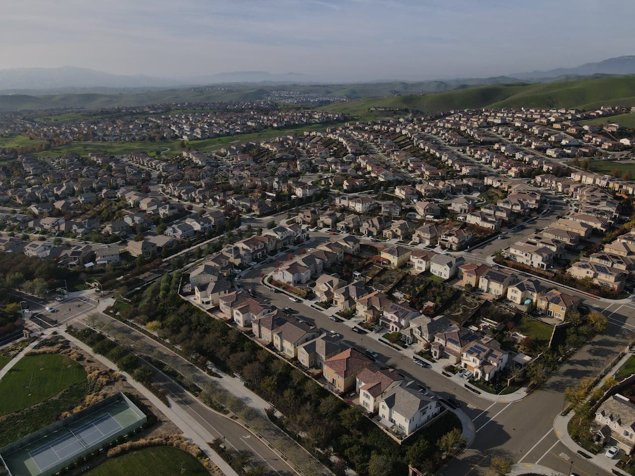 Aerial view of suburban homes in Dublin California Bay Area with rolling hills