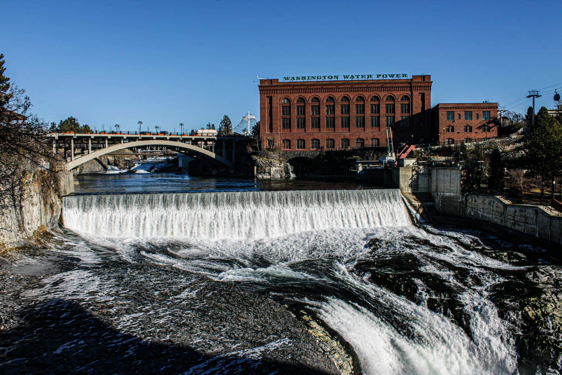 Spokane Falls waterfall with historic Washington Water Power building in background