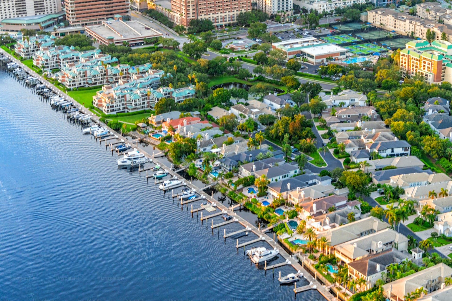 Aerial view of waterfront homes along Tampa Bay with boats and marina